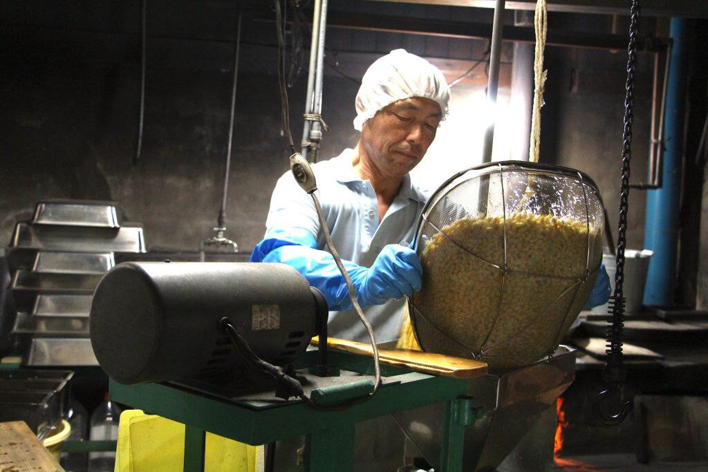 このお豆腐を作っている広島県出身の三島誠二さんは、古くから豆腐やこんにゃく作りが盛んに行われていた岩原地区の味を残したいと、18年前に奥様の実家である岩原地区に移住。お義母様の後を引き継ぎ、昔ながらの製法でお豆腐を作っています。